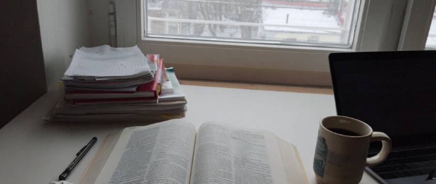 Uppslagen ordbok och anteckningar på ett skrivbord